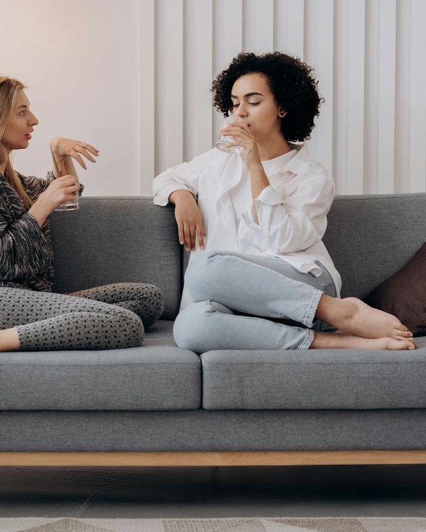 A diverse group of people sitting comfortably in a bright, calm room with natural light.